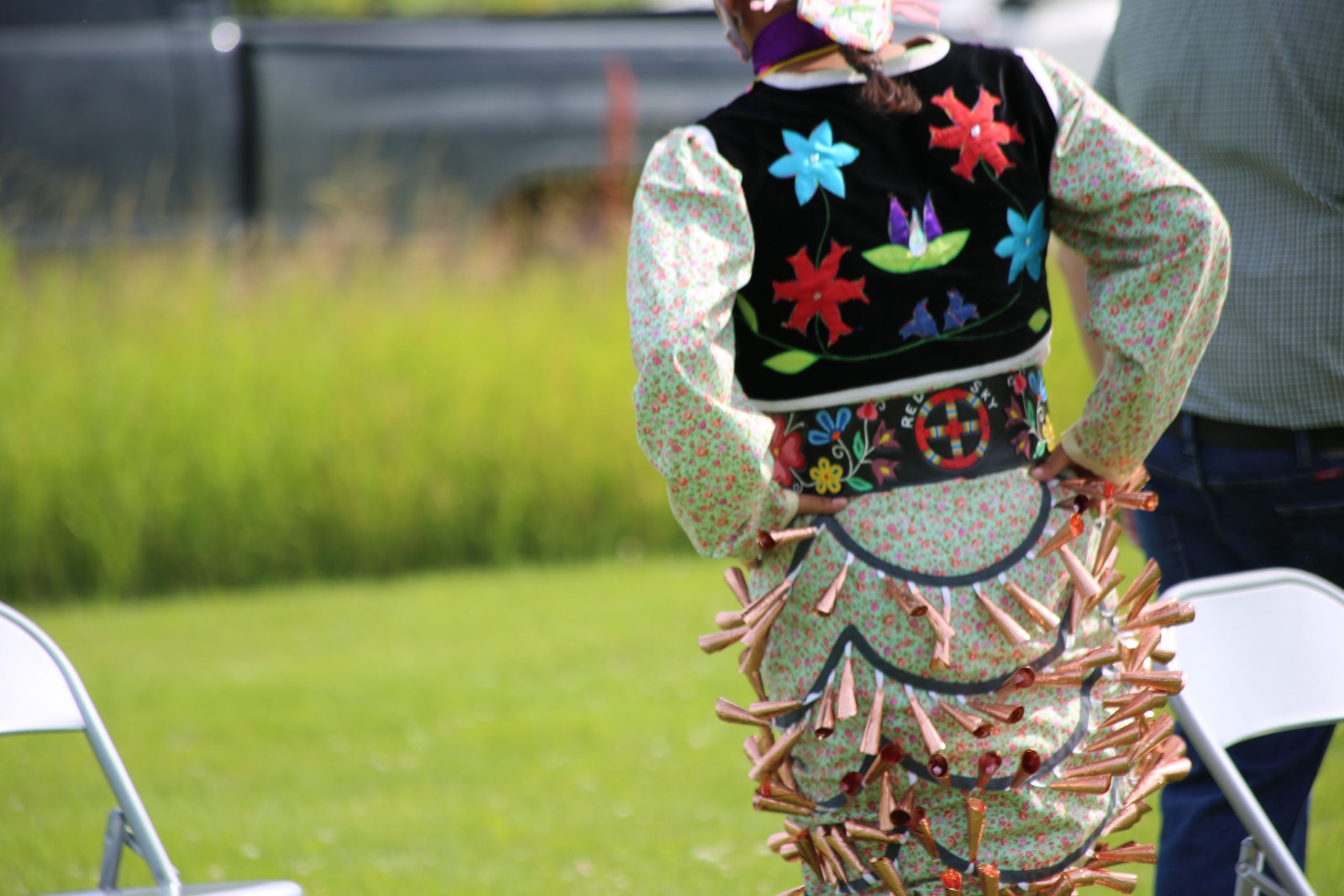A dancer in ceremonial beaded dress.