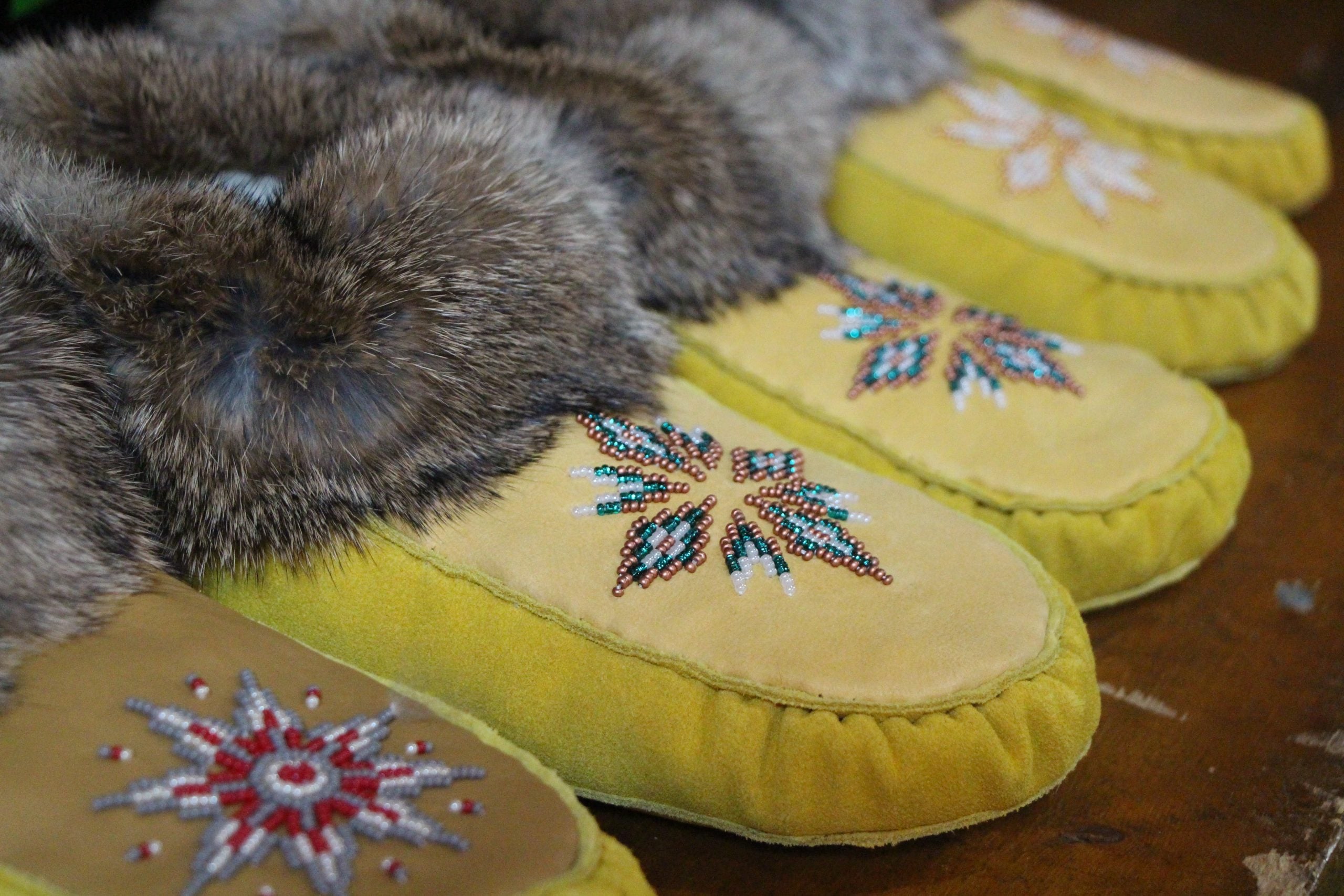 A row of beaded moccasins lined up.