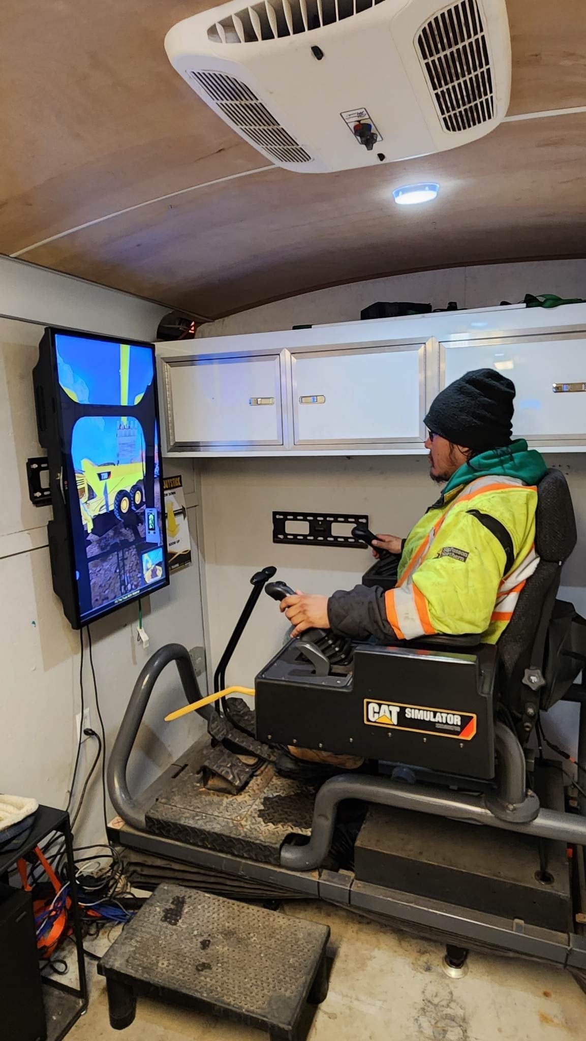 Person using a CAT construction simulator.