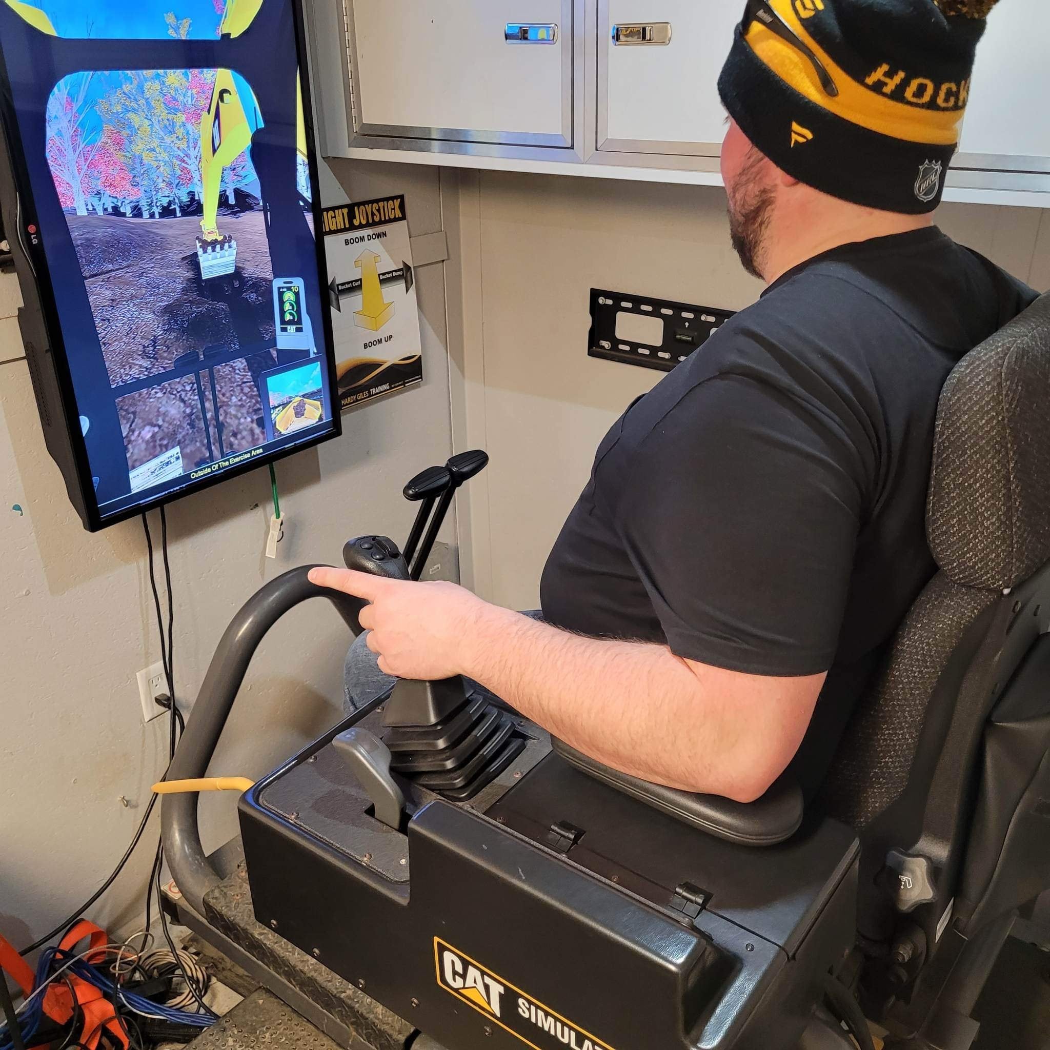 Person using a CAT construction simulator.